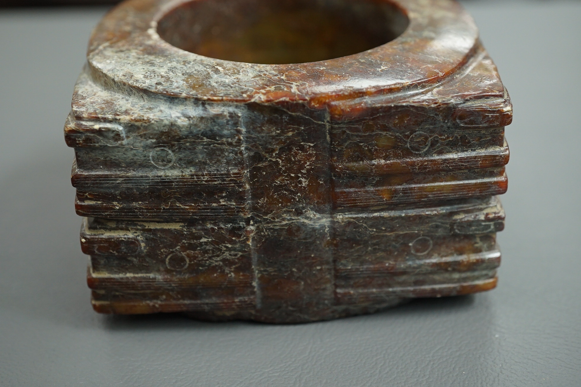 Four Chinese archaistic hardstone or burnt jade cong or cylinders